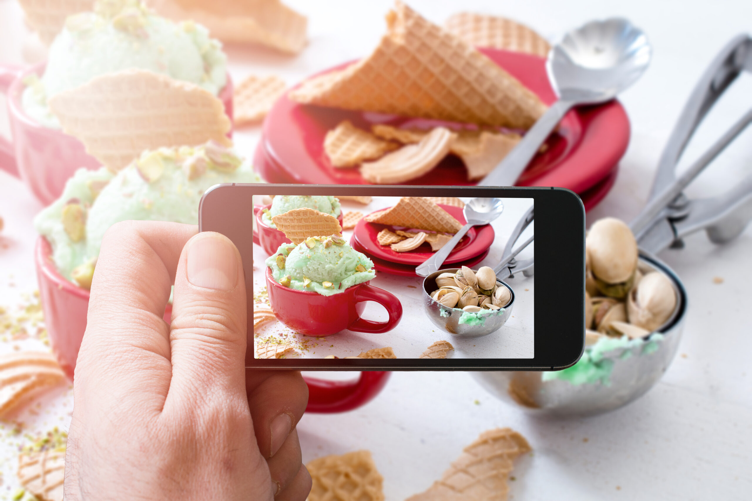 Photographing pistachios ice cream with cellphone camera,selective focus